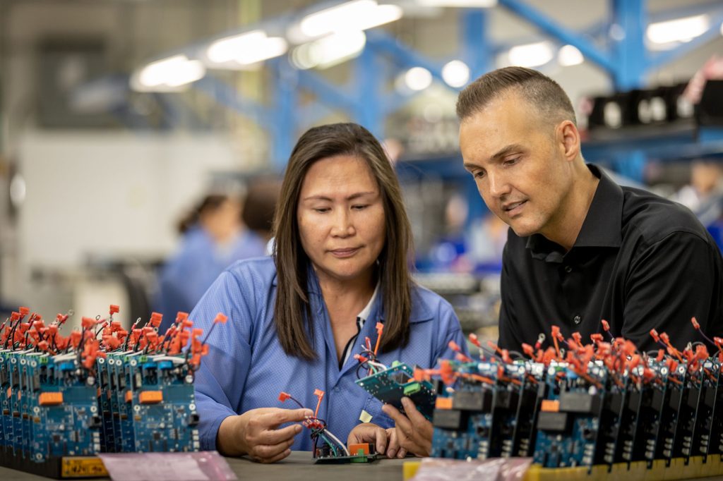 Man and woman assemble circuits