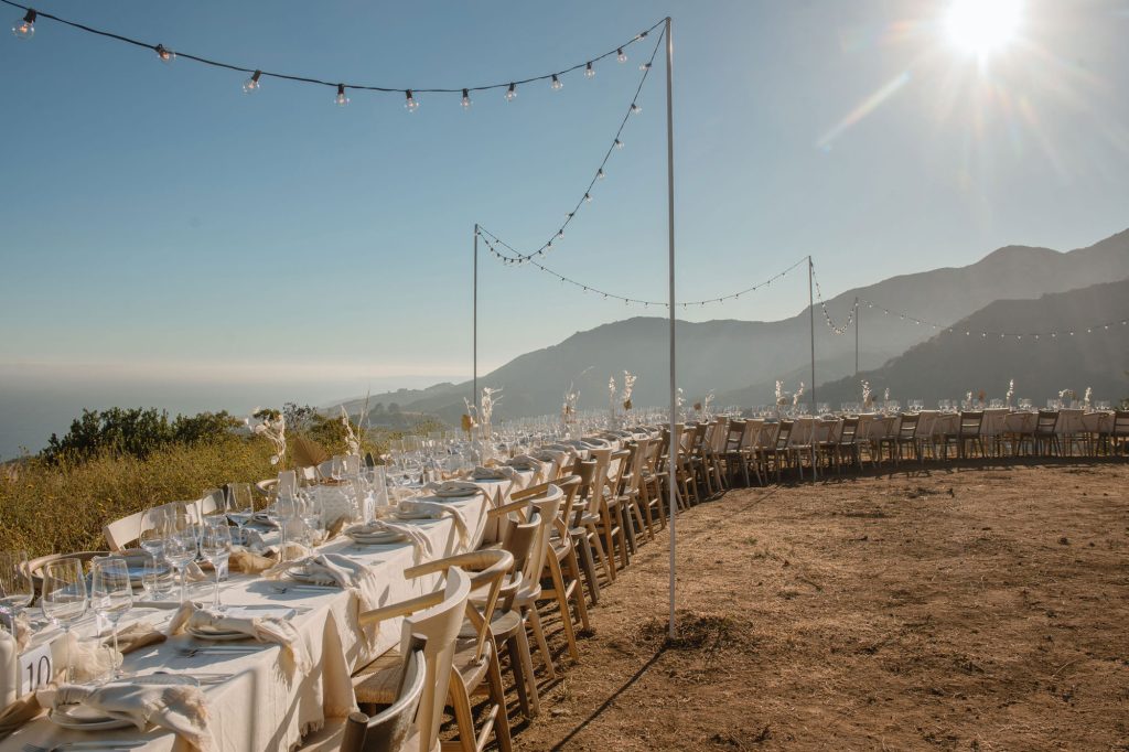 A communal table set up on a bluff in Malibu overlooking the ocean
