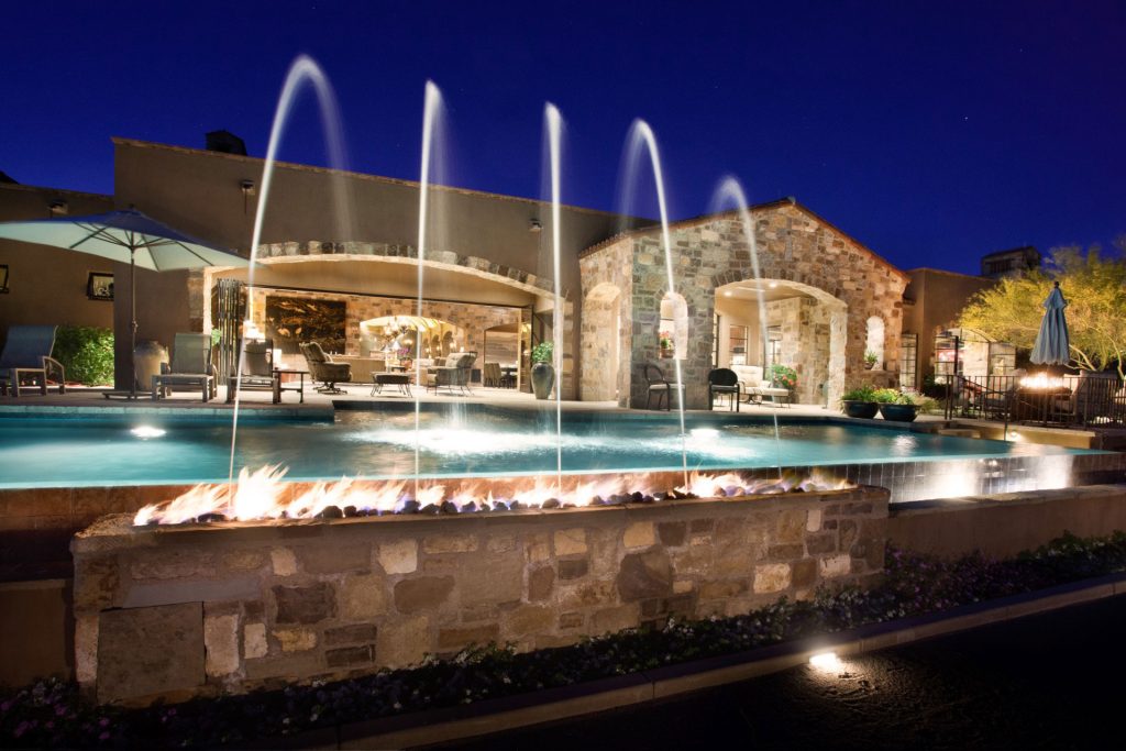 Fire feature with fountain next to a pool