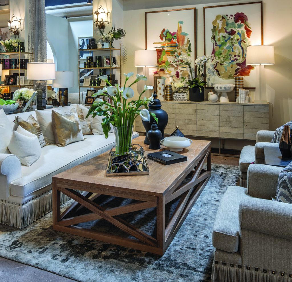 A vignette of a white couch and wood coffee table in a furniture showroom