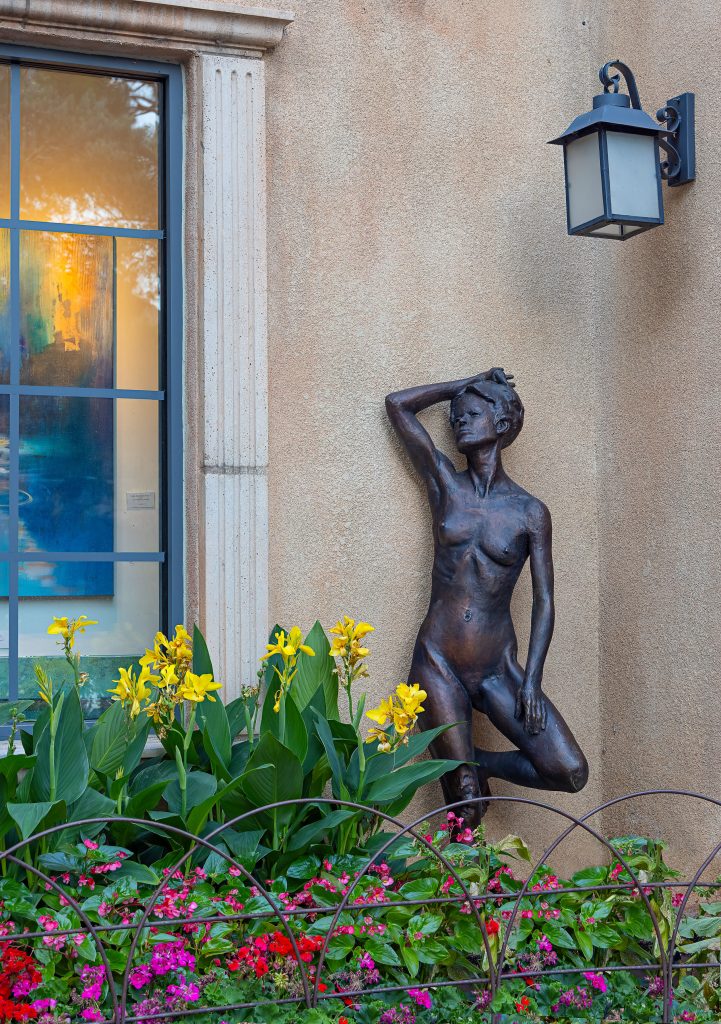 Sculpture of a nude woman posing against a wall by John Henry Waddell