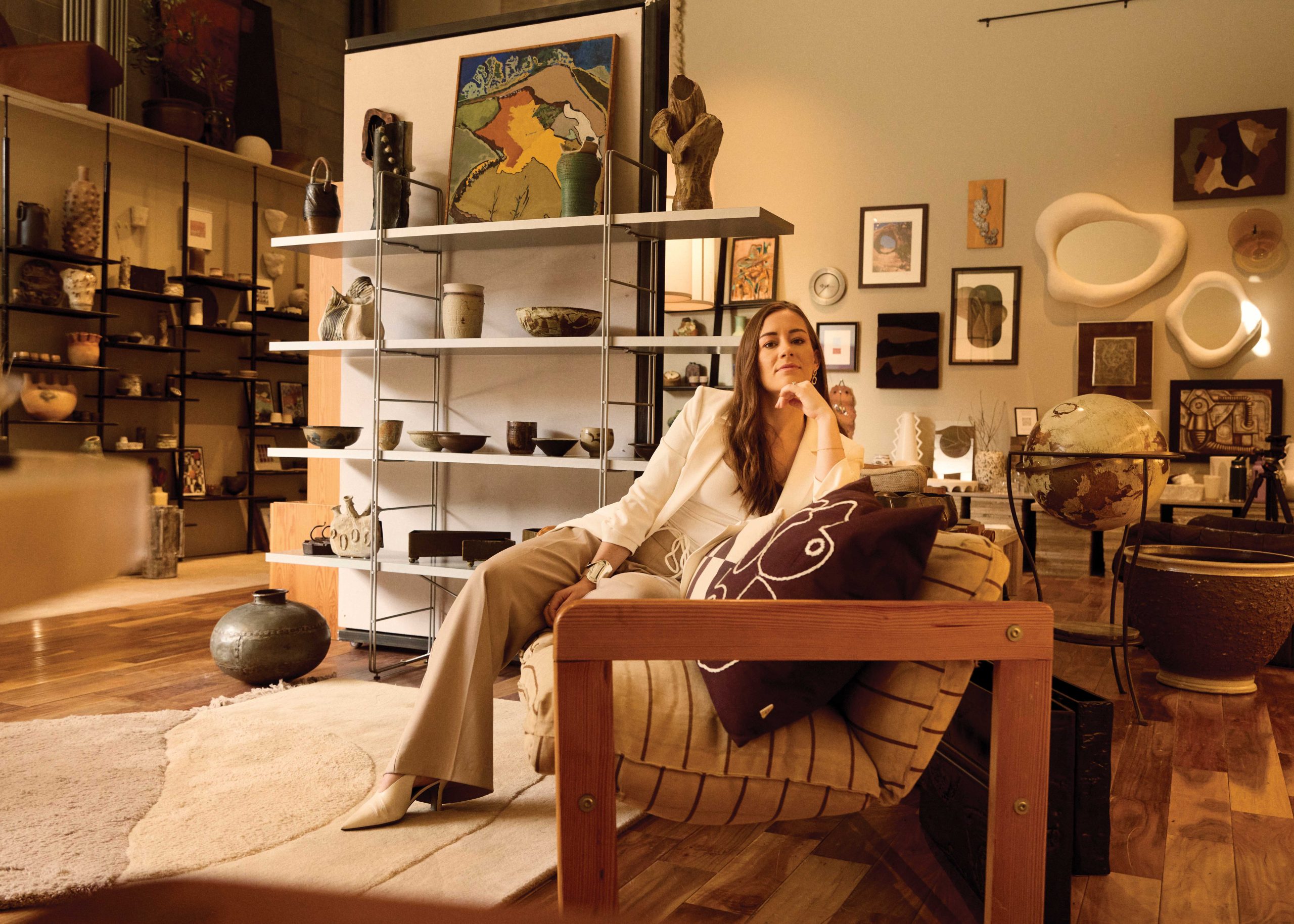 Kaitlyn Wolfe sits amid her treasures at Shop My Warehouse.