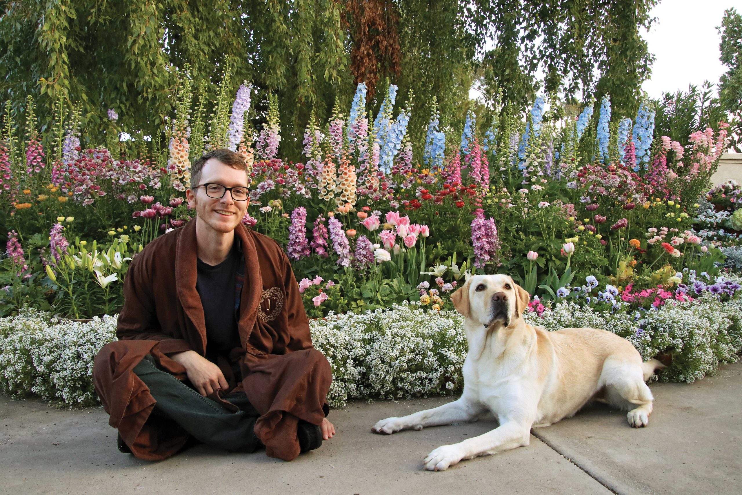 John and Kyle began casually gardening in their robes for social media posts and it proved popular, so they kept doing it. “It’s a fun way to show people that you can be cozy and still garden,” says John, shown here with their dog, Rose.