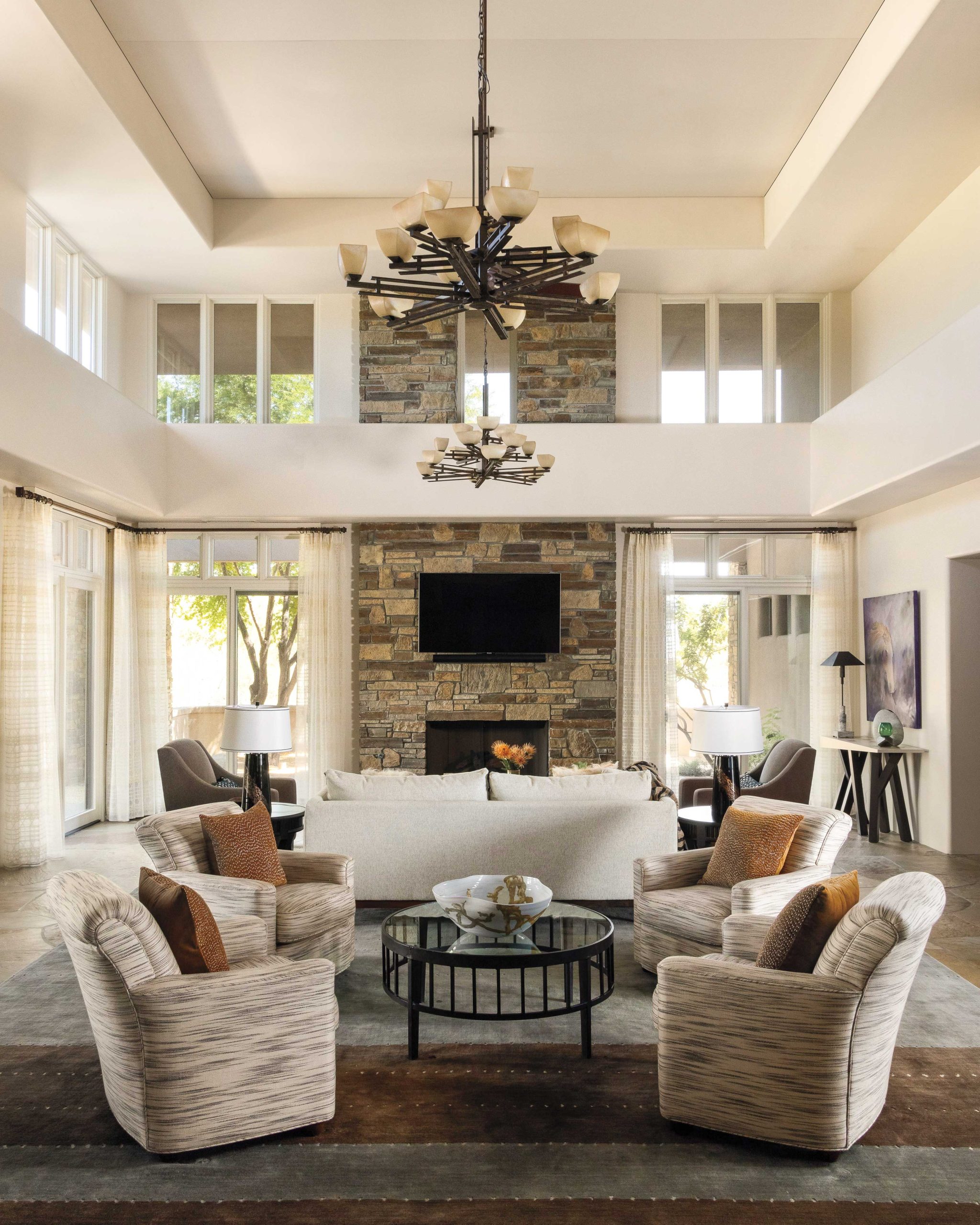The interior designer replaced heavy draperies with sheers that add a soft touch to the living room. She also brought in Mesa acoustics expert Tony Sola to help mitigate the echo challenge of the two-story volume. He suggested subtle upholstered panels in the room’s upper reaches, with a color tone that blends with the interior’s new cream paint scheme.