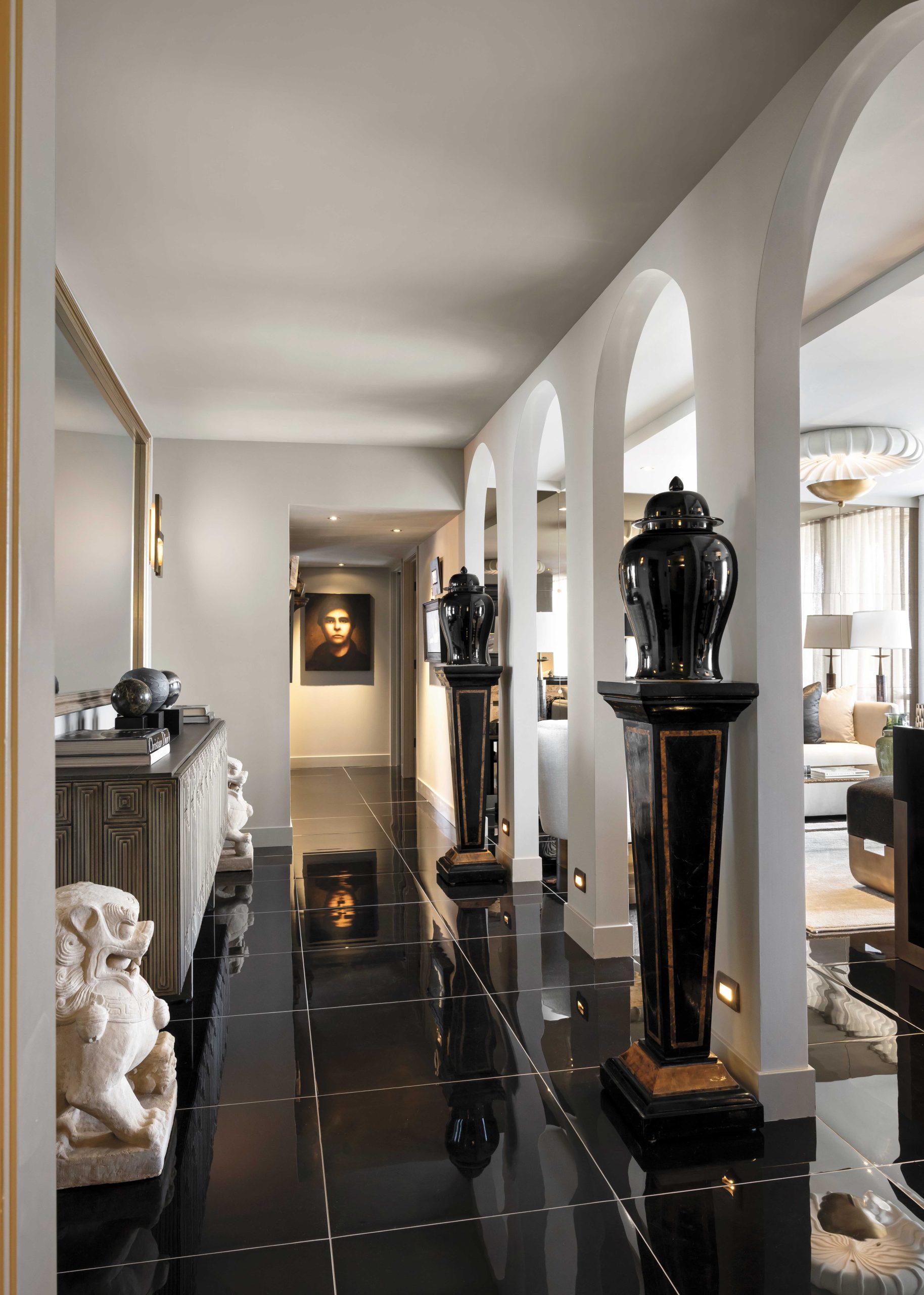“I have always wanted a high-gloss black art deco floor,” McIntyre says of the dramatic, reflective tiles. “It calls to mind one of those fabulous early Hollywood movies. I always have a bit of Hollywood Regency and glam midcentury and Asian influences.” He was also inspired by The Olympus’s exterior arch detail. “I thought, ‘Well, let’s bring a colonnade in.’ It’s the nucleus of the house.”