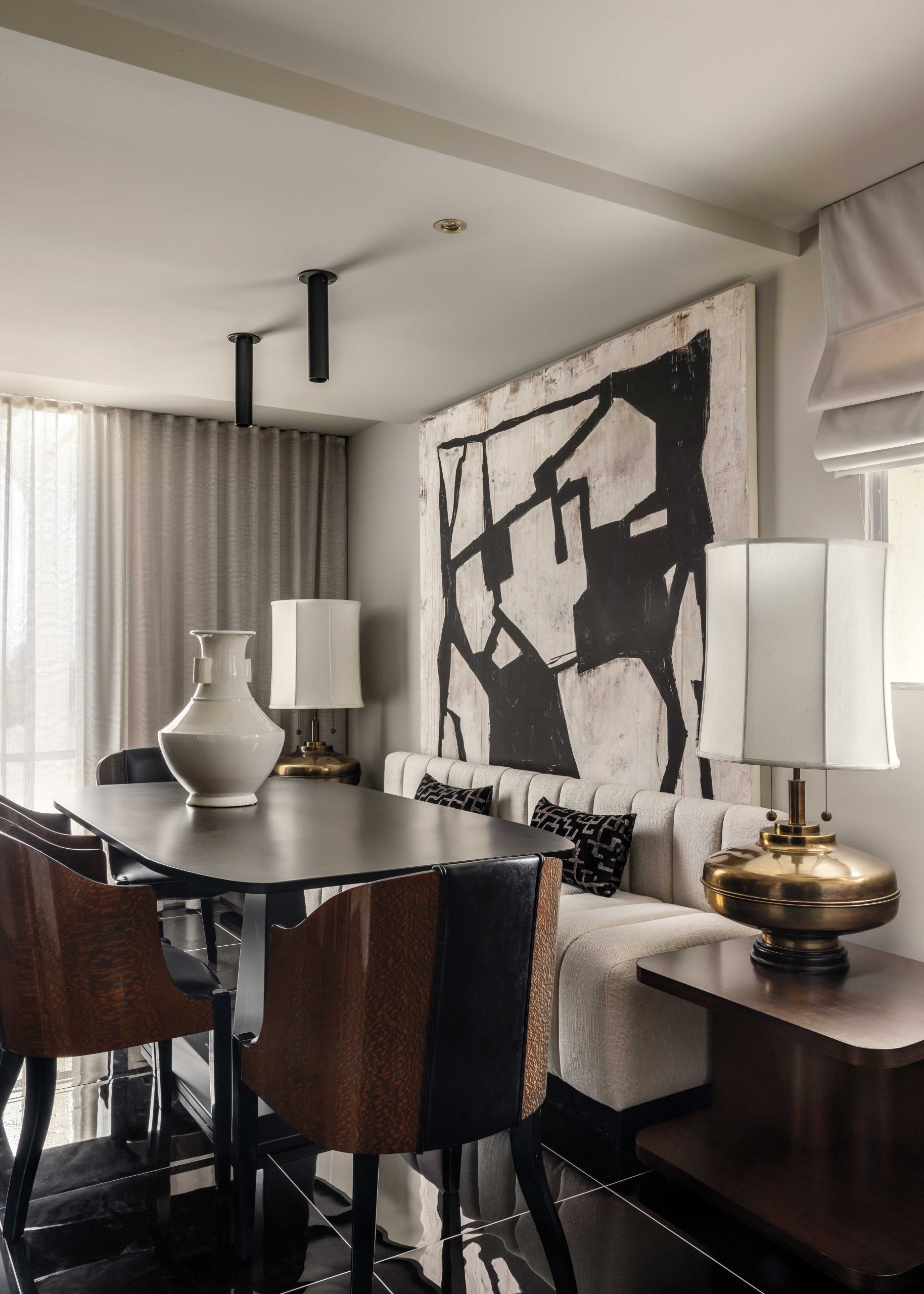 The designer envisioned a “dining room-slash-entertainment lounge with a banquette,” McIntyre says. “Hopefully it feels more like a speakeasy.” The plush seating was custom-made, and the art deco chairs were purchased from a collector friend. Midcentury brass lamps are finds from a local vintage store.