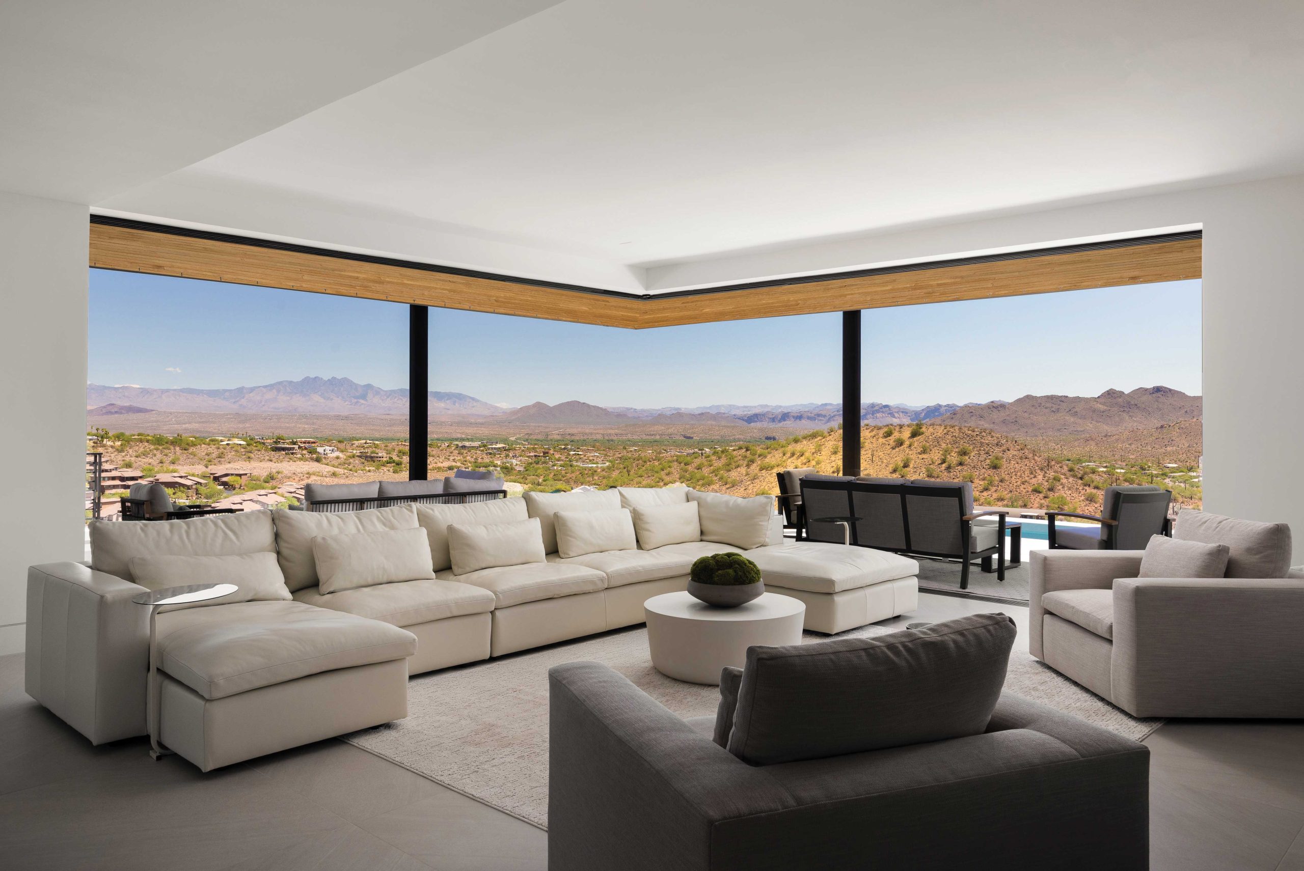 One of the home’s standout features is the great room, which features two walls of windows that disappear into pockets and open with the push of a button. “Capturing the views was a top priority,” Tsontakis says. Because the home is solar-powered, the windows are often open day and night. “Because you don’t have the cost of the energy, you can have an indoor-outdoor experience without having to open and close doors and windows,” the architect observes. Interior designer Emily Marek’s choice of furnishings was intentional. “We didn’t want to bring any pops of color into this space; we wanted to keep it very neutral for that backdrop to really speak.”