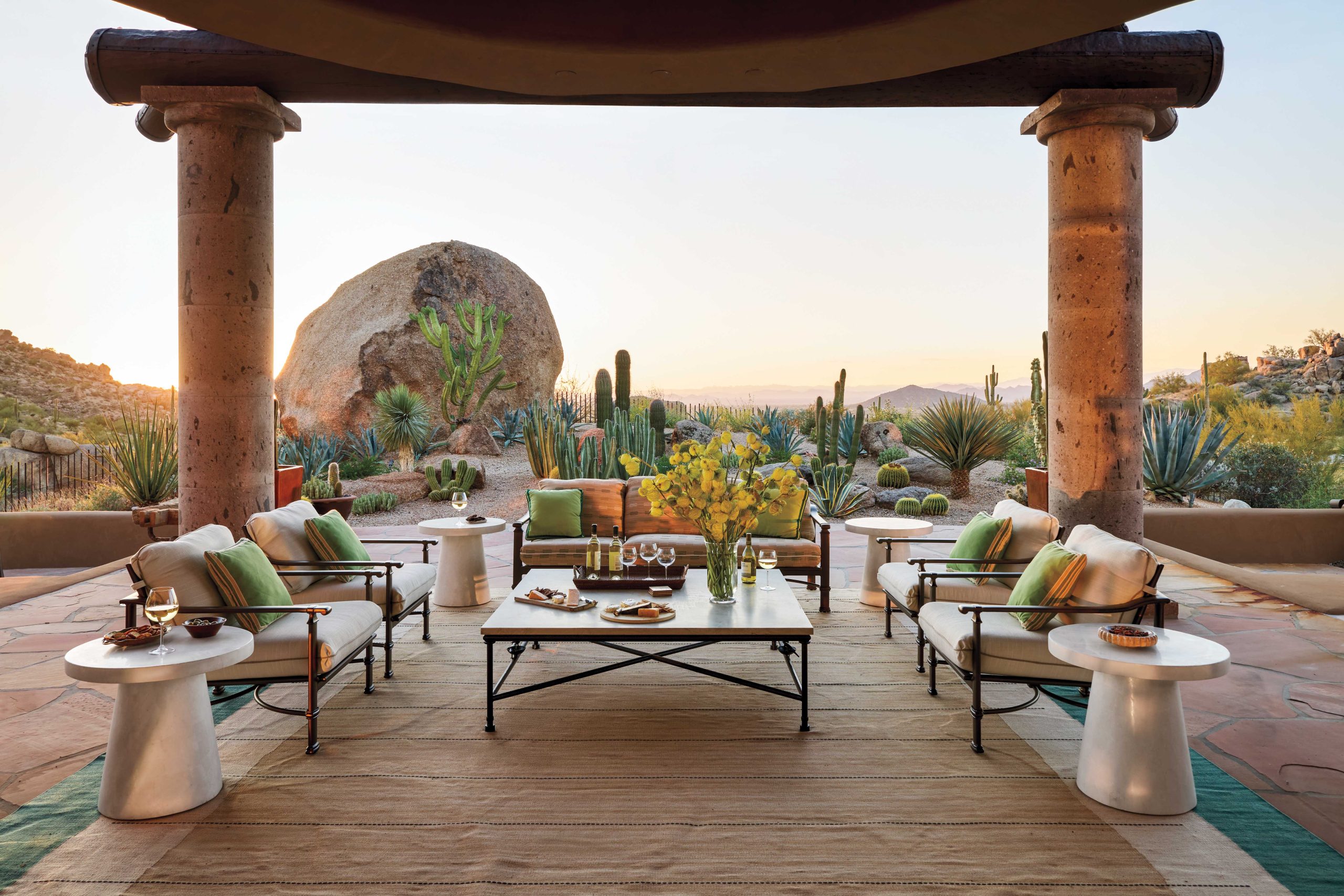 In the back off the living room, landscape designer Chad Norris expanded the view by removing a platform fire pit that once stood next to the massive boulder, recontouring the site and adding in saguaros, organ pipe and senita cactus, as well as agaves and yuccas. “We brought in more boulders,” says Norris, “and the only way to get them back there was to bring them through the living room, which was totally under construction at the time.”