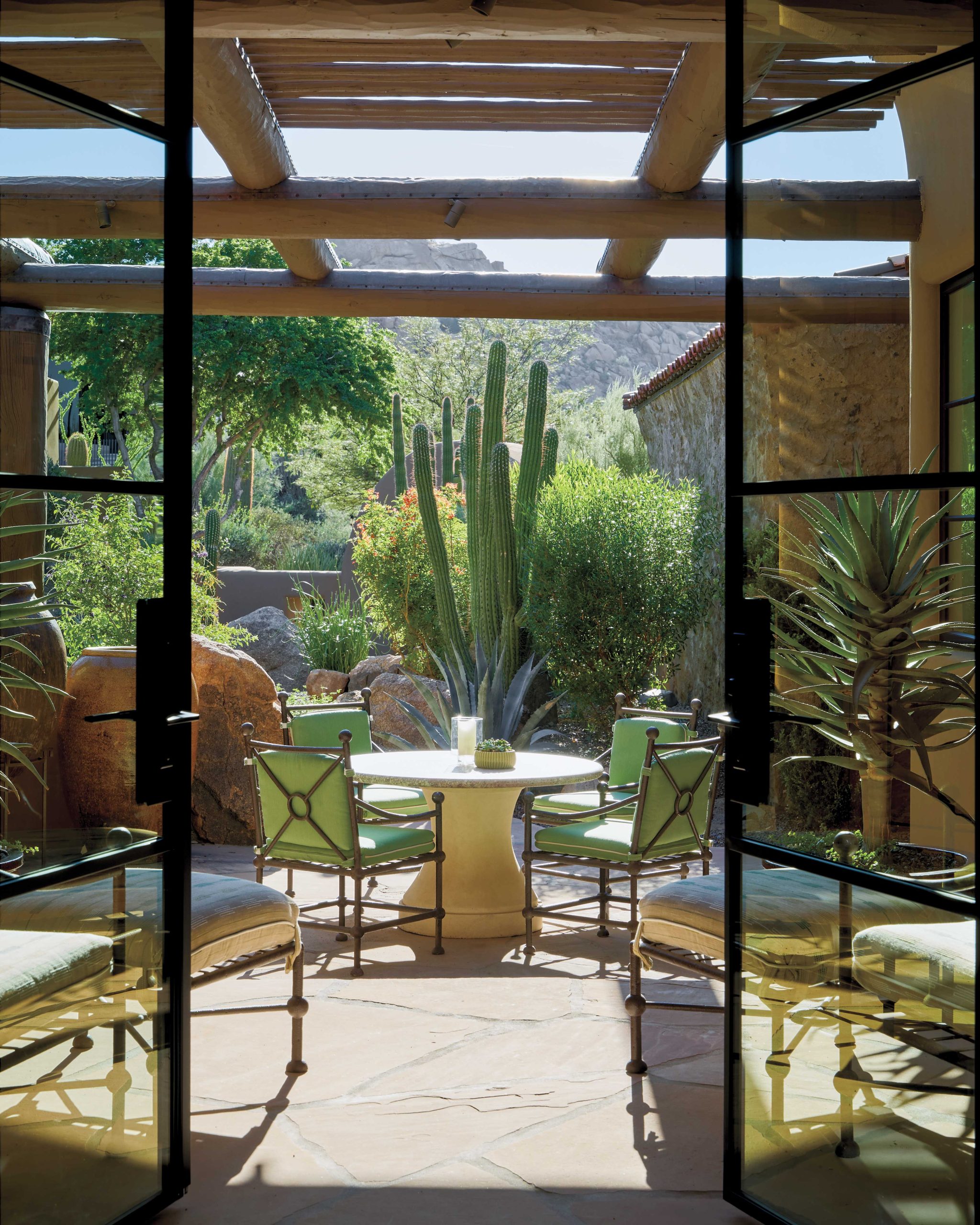 A private courtyard at the front of the house was revitalized by Norris with an Argentine toothpick cactus and a Hercules aloe that serve as a living sculptures. The boulders are part of a water feature that runs through the front yard.